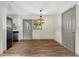 Dining area featuring updated flooring, contemporary lighting, and access to the kitchen and adjacent rooms at 3152 Ridgecrest Dr, Powder Springs, GA 30127