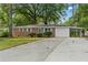 Charming brick home featuring a garage and carport, surrounded by mature trees and a spacious driveway at 3152 Ridgecrest Dr, Powder Springs, GA 30127