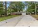 Charming single story brick home with mature trees, green grass, and a spacious driveway leading to a one-car garage at 3152 Ridgecrest Dr, Powder Springs, GA 30127