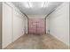Spacious single car garage featuring concrete floor, white walls, and a pink insulated door at 3152 Ridgecrest Dr, Powder Springs, GA 30127