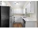 Bright kitchen with stainless steel appliances, white cabinetry, and quartz countertops, offering a modern and clean aesthetic at 3152 Ridgecrest Dr, Powder Springs, GA 30127