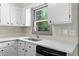 Updated kitchen featuring white cabinets, quartz countertops, stainless steel appliances, and a large window for natural light at 3152 Ridgecrest Dr, Powder Springs, GA 30127