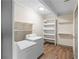 Laundry room with appliances, shelving, wood-look flooring, and a skylight at 3152 Ridgecrest Dr, Powder Springs, GA 30127