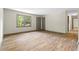 Living room featuring updated flooring, a large window, and neutral walls, transitioning seamlessly into the hallway at 3152 Ridgecrest Dr, Powder Springs, GA 30127