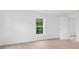 Bedroom with light wood flooring and a view of lush greenery outside the window at 331 Highway 162, Covington, GA 30016