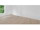 A spacious bedroom with light wood flooring, a window, and a closet at 331 Highway 162, Covington, GA 30016
