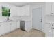 Updated kitchen showcasing white cabinets, modern sink fixtures, and stainless steel dishwasher at 331 Highway 162, Covington, GA 30016