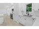 Bright kitchen with white cabinetry, stainless appliances, and a view to the outdoor scenery at 331 Highway 162, Covington, GA 30016
