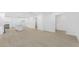Open-concept living room and kitchen area, featuring light hardwood floors and white walls at 331 Highway 162, Covington, GA 30016