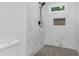 Tiled walk-in shower features a window and built in niche at 331 Highway 162, Covington, GA 30016
