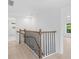 Upper staircase landing with wood and iron railings at 331 Highway 162, Covington, GA 30016
