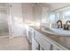 Bathroom featuring double sinks, tile countertops, and a glass-enclosed shower at 335 Wilma Sw Ct, Atlanta, GA 30331