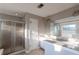 Bathroom featuring double sinks, tile countertops, and a glass-enclosed shower at 335 Wilma Sw Ct, Atlanta, GA 30331