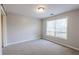 Neutral bedroom with a large window and carpeted floors at 335 Wilma Sw Ct, Atlanta, GA 30331