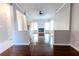 Open-concept living room with hardwood floors and abundant natural light streaming through large windows at 335 Wilma Sw Ct, Atlanta, GA 30331