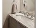 Bathroom featuring marble countertop, brushed-nickel faucet, and decorative mirror at 3895 Old Atlanta Station Se Dr # 1, Atlanta, GA 30339