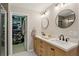Bathroom showcasing double vanities, a walk-in closet, and modern fixtures at 3895 Old Atlanta Station Se Dr # 1, Atlanta, GA 30339