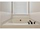 Bright bathroom with a pristine white bathtub and sleek, modern fixtures at 3895 Old Atlanta Station Se Dr # 1, Atlanta, GA 30339