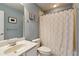 Cozy bathroom with a shower, toilet, vanity sink, mirror, and decorative art on the light blue walls at 3895 Old Atlanta Station Se Dr # 1, Atlanta, GA 30339