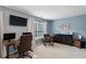 Spacious bedroom featuring an office space, rocking chair, dark dresser, and neutral-toned walls at 3895 Old Atlanta Station Se Dr # 1, Atlanta, GA 30339