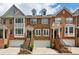 Charming brick townhomes featuring well-manicured landscaping and attached garages at 3895 Old Atlanta Station Se Dr # 1, Atlanta, GA 30339