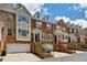 Row of well-maintained townhomes with brick facades, front-entry garages, and attractive landscaping at 3895 Old Atlanta Station Se Dr # 1, Atlanta, GA 30339