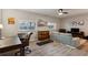 Open-concept living room with hardwood floors, a sofa, tv, desk, treadmill, and a mini-fridge at 3895 Old Atlanta Station Se Dr # 1, Atlanta, GA 30339