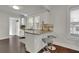 Bright kitchen with white cabinetry, granite countertops, and stainless steel appliances with seating at the breakfast bar at 265 Haas Se Ave, Atlanta, GA 30316