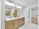 Bright bathroom features a double sink vanity with modern fixtures and a large mirror at 5773 Tillman Way, Powder Springs, GA 30127