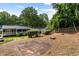 Spacious backyard featuring mature trees, wood fence, deck and play area at 1090 Shepherds Ne Ln, Atlanta, GA 30324
