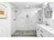 Modern bathroom featuring glass enclosed shower, marble counter, and white subway tile at 1090 Shepherds Ne Ln, Atlanta, GA 30324
