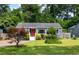 Charming blue home with a bright red door and a well-manicured lawn with lush landscaping at 1090 Shepherds Ne Ln, Atlanta, GA 30324