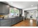 Updated kitchen boasts gray cabinets, stainless appliances, and hardwood flooring at 1090 Shepherds Ne Ln, Atlanta, GA 30324