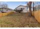 Wide shot of the fenced in backyard with a gentle slope and mature trees at 1104 Oak Knoll Se Ter, Atlanta, GA 30315