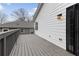 Side view of gray wood deck on a house with white siding and black trim at 1104 Oak Knoll Se Ter, Atlanta, GA 30315