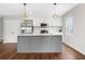 Modern kitchen showcasing stainless steel appliances, white cabinets, and a gray island at 1104 Oak Knoll Se Ter, Atlanta, GA 30315
