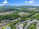 Neighborhood aerial shot highlighting townhomes with tennis court and landscape at 1628 Indian Way, Cumming, GA 30040