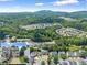 Community aerial view highlights location featuring trees, townhomes, and rolling hills at 1628 Indian Way, Cumming, GA 30040