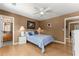 Bedroom featuring a ceiling fan, a bed, and an open doorway to the bathroom and another room at 1628 Indian Way, Cumming, GA 30040