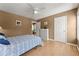 Bedroom showing wood floors, a ceiling fan, a window, and an open door and closed closet door at 1628 Indian Way, Cumming, GA 30040