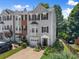 Attractive townhome featuring manicured lawn, black shutters, and a one-car garage at 1628 Indian Way, Cumming, GA 30040