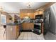 Bright kitchen featuring stainless steel appliances, wooden cabinets, laminate countertop, and tiled floor at 1628 Indian Way, Cumming, GA 30040