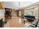 Bright living room featuring hardwood floors, a fireplace, stylish sofas, and large windows at 1628 Indian Way, Cumming, GA 30040