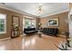 Bright living room featuring hardwood floors, a fireplace, stylish sofas, and large windows at 1628 Indian Way, Cumming, GA 30040