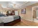 Main bedroom with decorative tray ceiling, wood floors, ensuite bathroom and large closet at 1628 Indian Way, Cumming, GA 30040