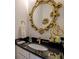 Beautiful bathroom with an ornate mirror and granite countertop at 2587 Alvecot Se Cir, Atlanta, GA 30339
