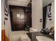 Modern bathroom with dark brick shower, vanity and black countertop at 2587 Alvecot Se Cir, Atlanta, GA 30339