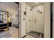 Bathroom with a modern glass shower and gold fixtures next to Primary bedroom at 2587 Alvecot Se Cir, Atlanta, GA 30339