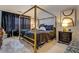 Tranquil bedroom featuring a four poster bed, dark accents, and modern decor at 2587 Alvecot Se Cir, Atlanta, GA 30339