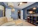 Spacious bedroom with a large TV, a walk-in closet, neutral carpet, and blue walls at 2587 Alvecot Se Cir, Atlanta, GA 30339